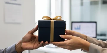 Hands exchanging a gift, symbolizing the 2026 gift tax exclusion and wealth transfer strategies