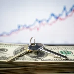 Interest Rate Hikes: Fed's 0.25% Increase & Your Mortgage House key on dollar bills with rising interest rate graph